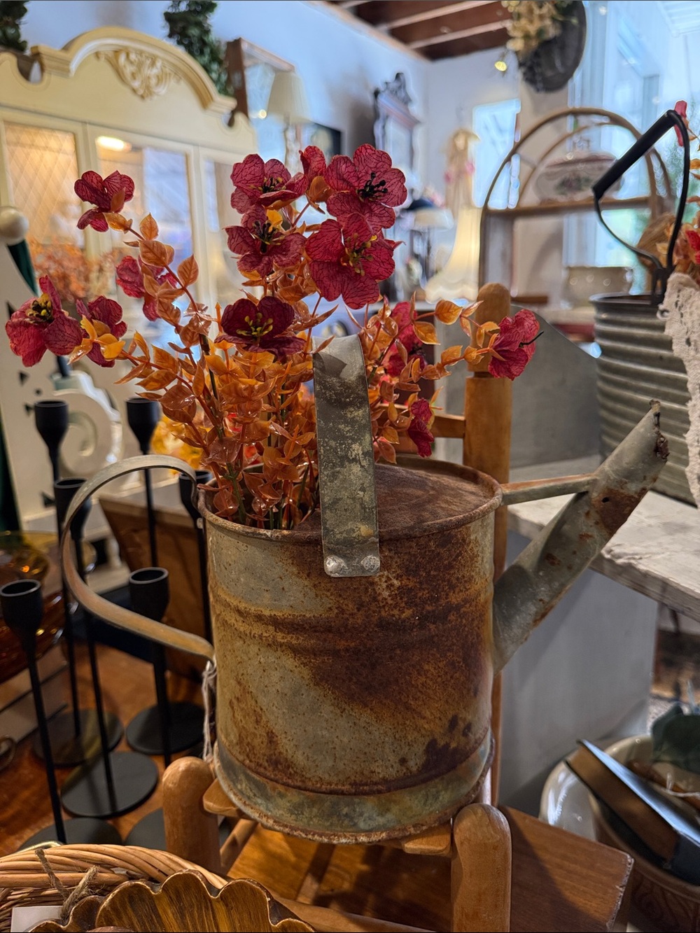 Rustic Metal Watering Can Vase with Red and Orange Floral Accents